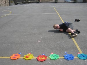 Maths in the sun. Some of the children managed to sort and count in groups of five all on their own - fantastic!